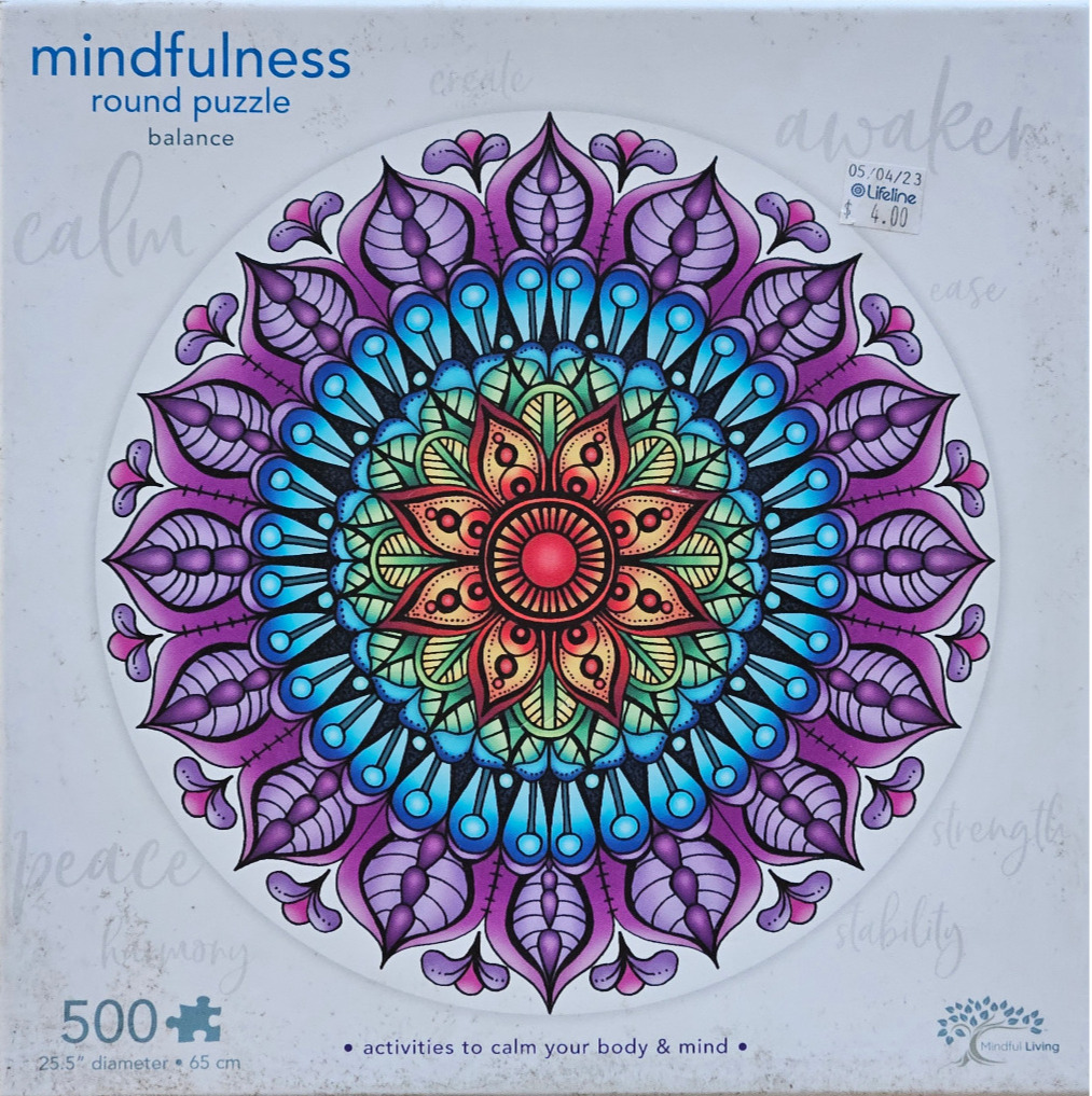 A colorful, symmetrical circular mandala illustration with purple, blue, and warm tones on a light background.