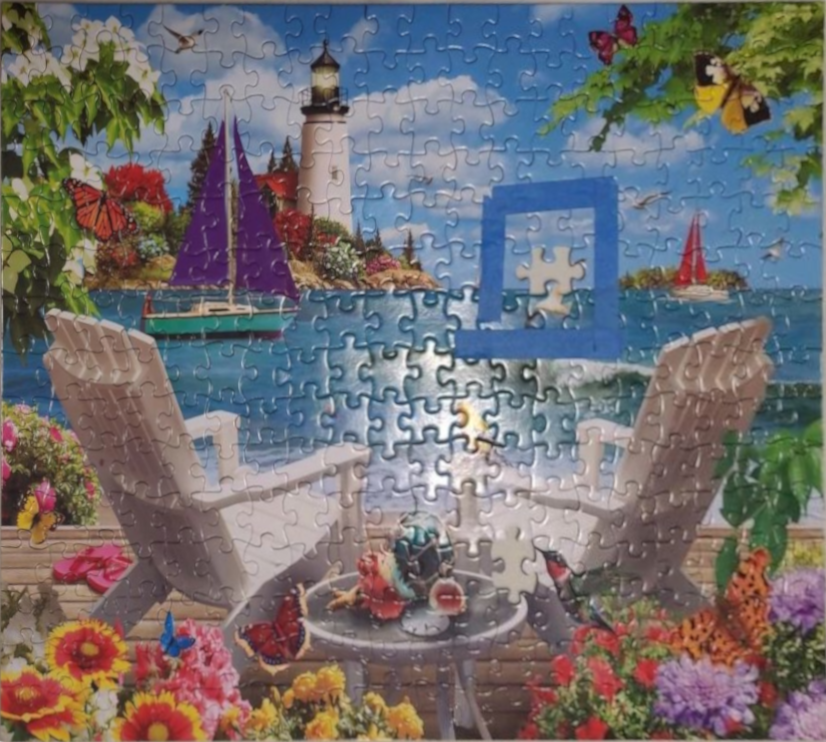 Coastal scene with two lounge chairs, a table, and sailboats by a lighthouse, decorated with flowers and butterflies.