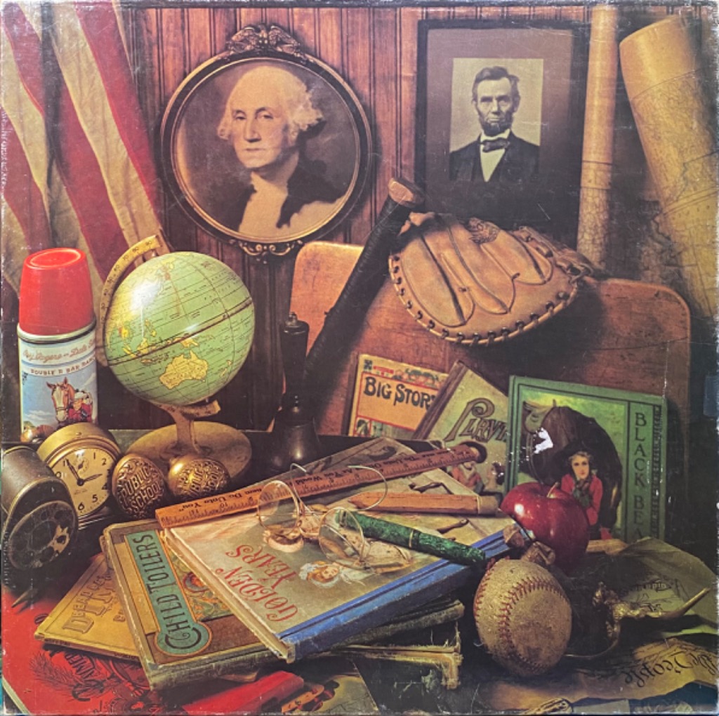 A nostalgic still life arrangement of Americana, including portraits, books, a globe, and sports equipment.