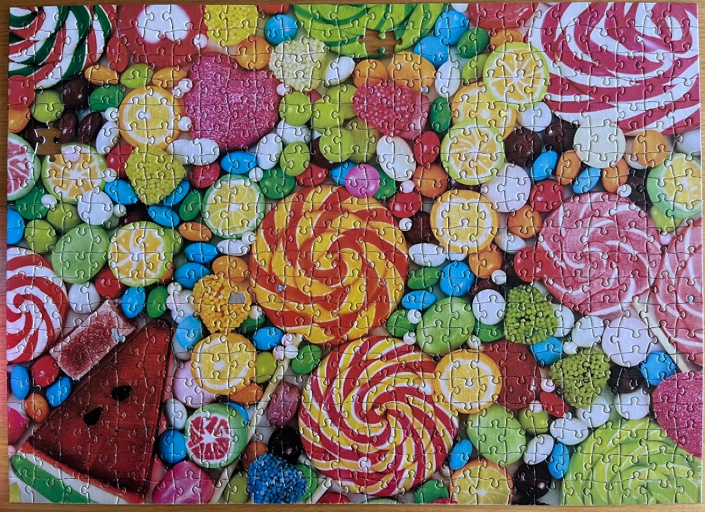 A dense, vibrant collection of assorted colorful hard candies and lollipops.