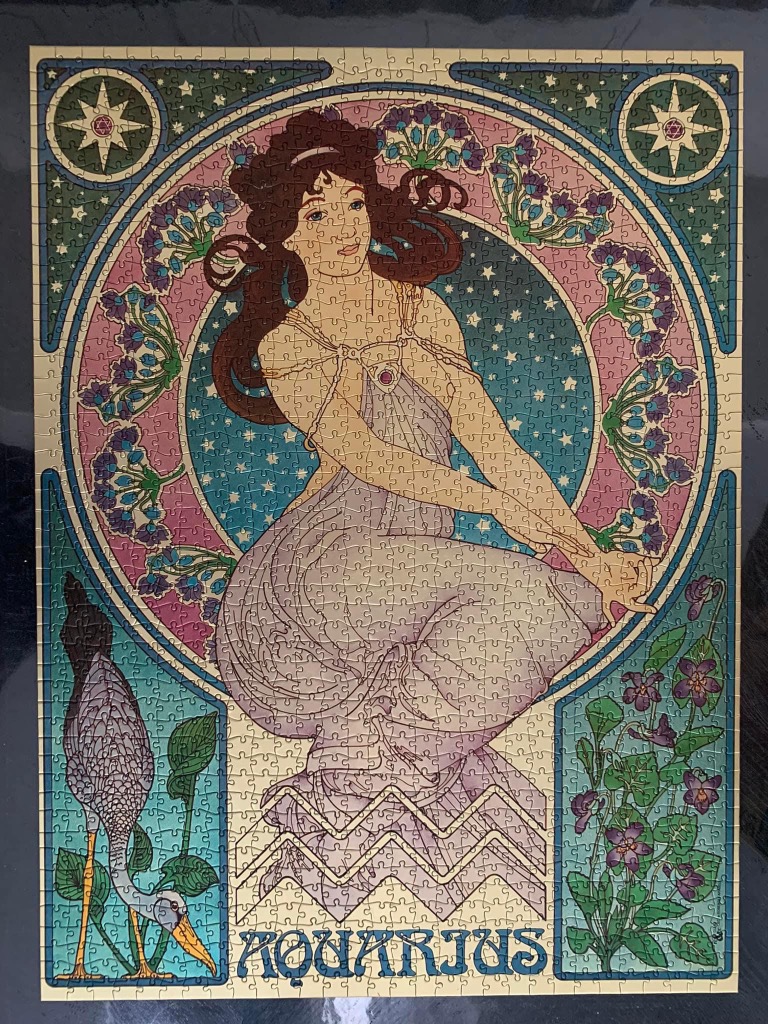 Art Nouveau style illustration of the Aquarius zodiac sign featuring a woman, flowers, and a water bird.