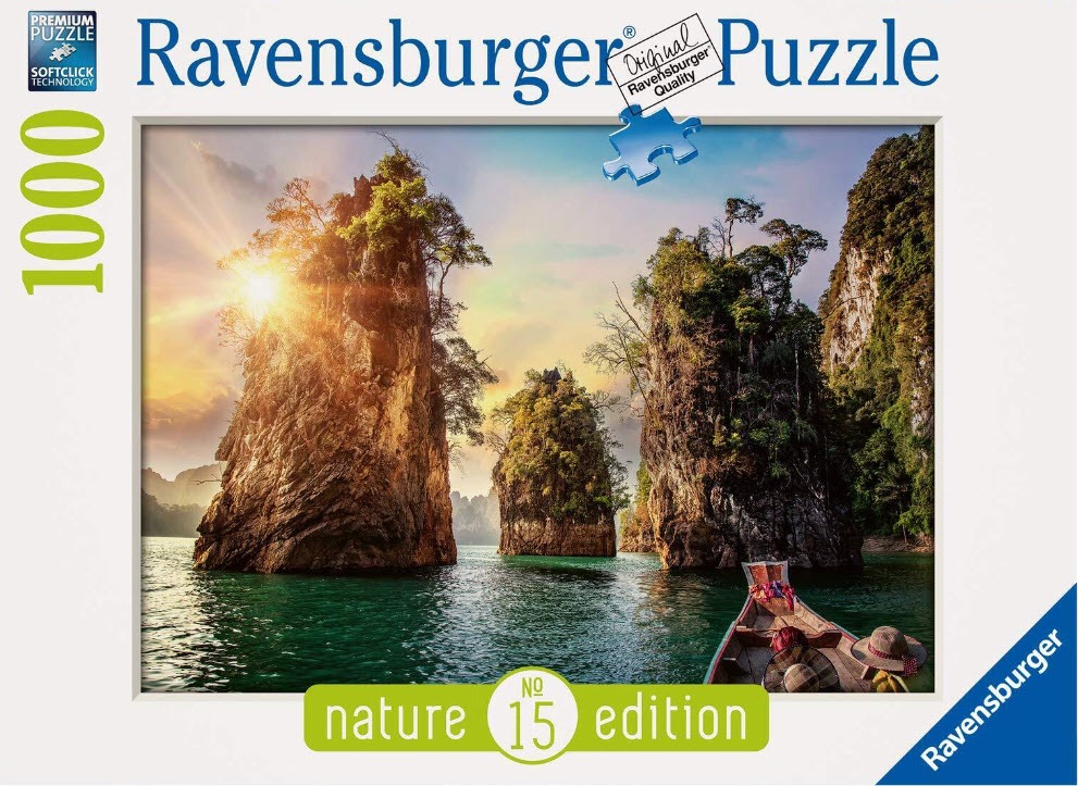 Scenic photograph of limestone karst islands rising from turquoise water in Thailand at sunset.