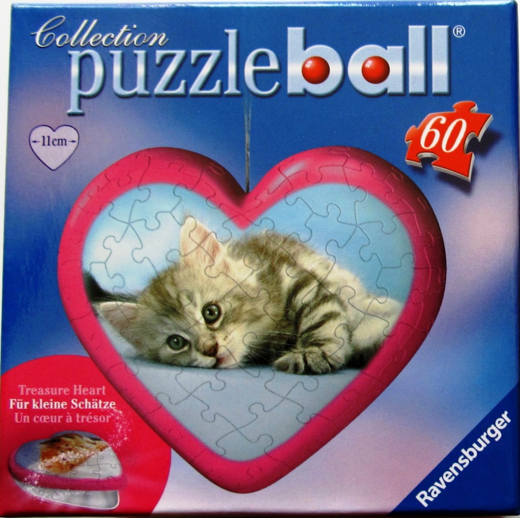 A fluffy tabby kitten reclining inside a pink heart shape