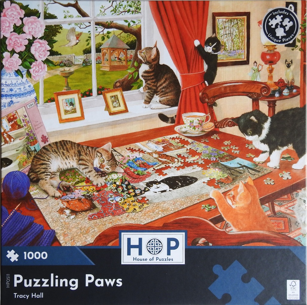 Several kittens interact with a jigsaw puzzle on a wooden table in a sunlit room filled with flowers and decor.