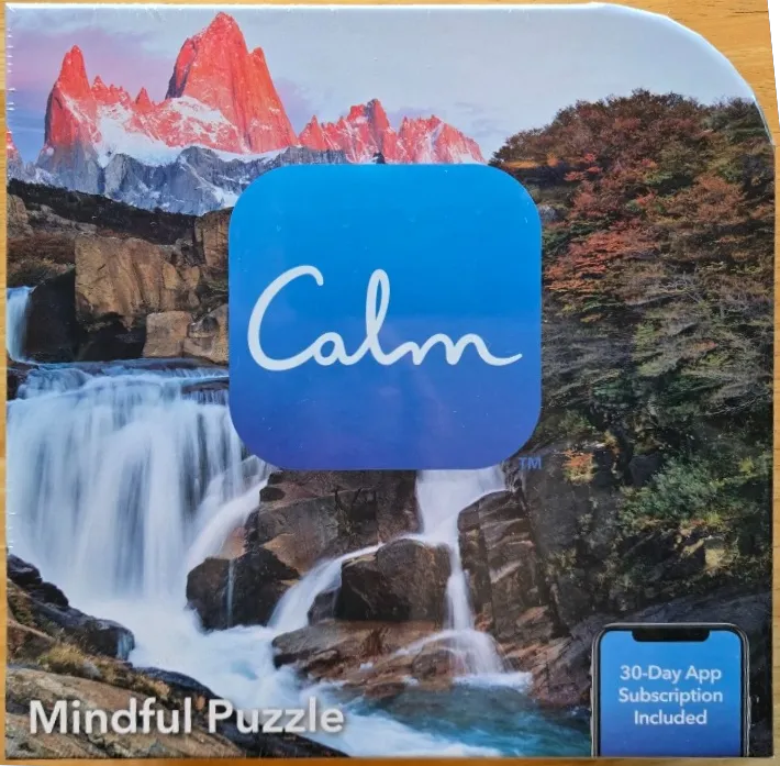 A scenic mountain landscape with a waterfall and a blue square logo overlay.