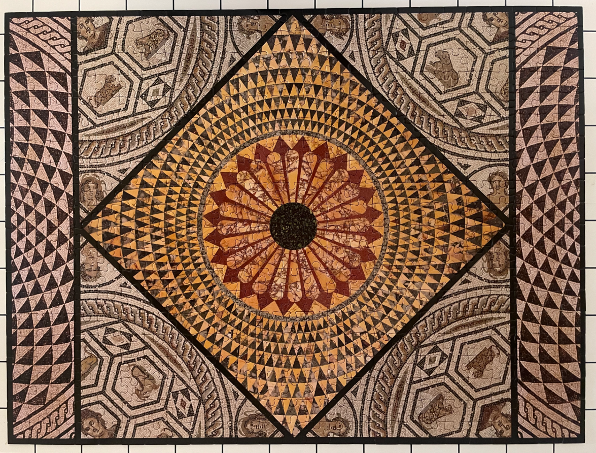 An intricate, geometric Roman-style mosaic floor design with a central starburst motif.