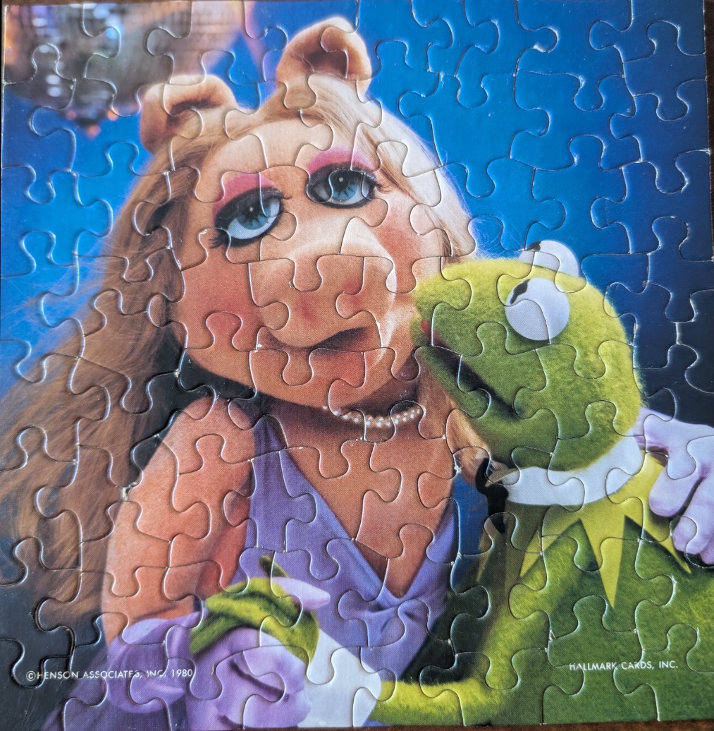 Miss Piggy and Kermit the Frog posing together in a close-up photograph