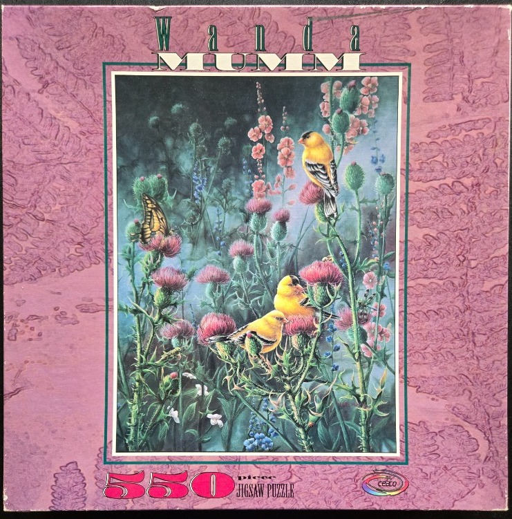 Illustration of goldfinches and a butterfly among tall thistles and pink wildflowers against a soft, misty background.