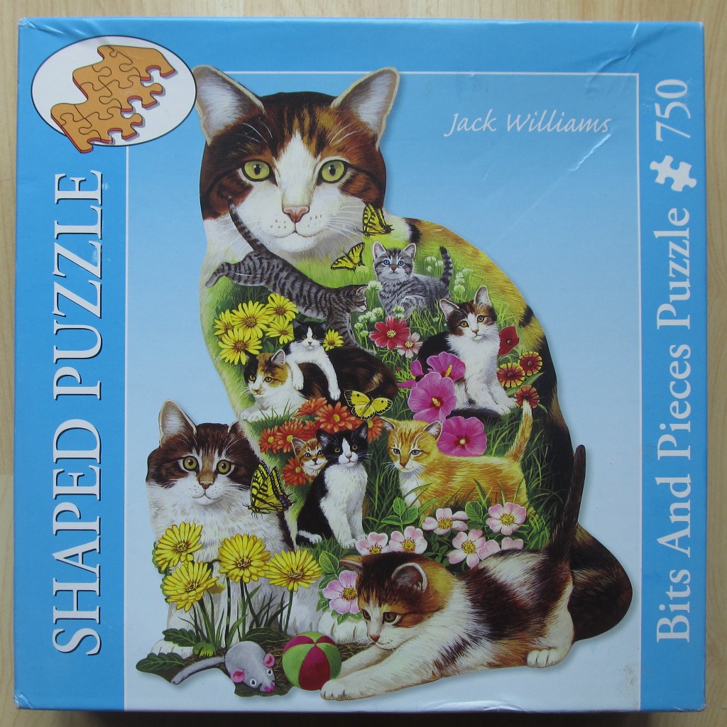 Artistic illustration of a large tabby cat silhouette filled with images of smaller kittens, flowers, and butterflies.