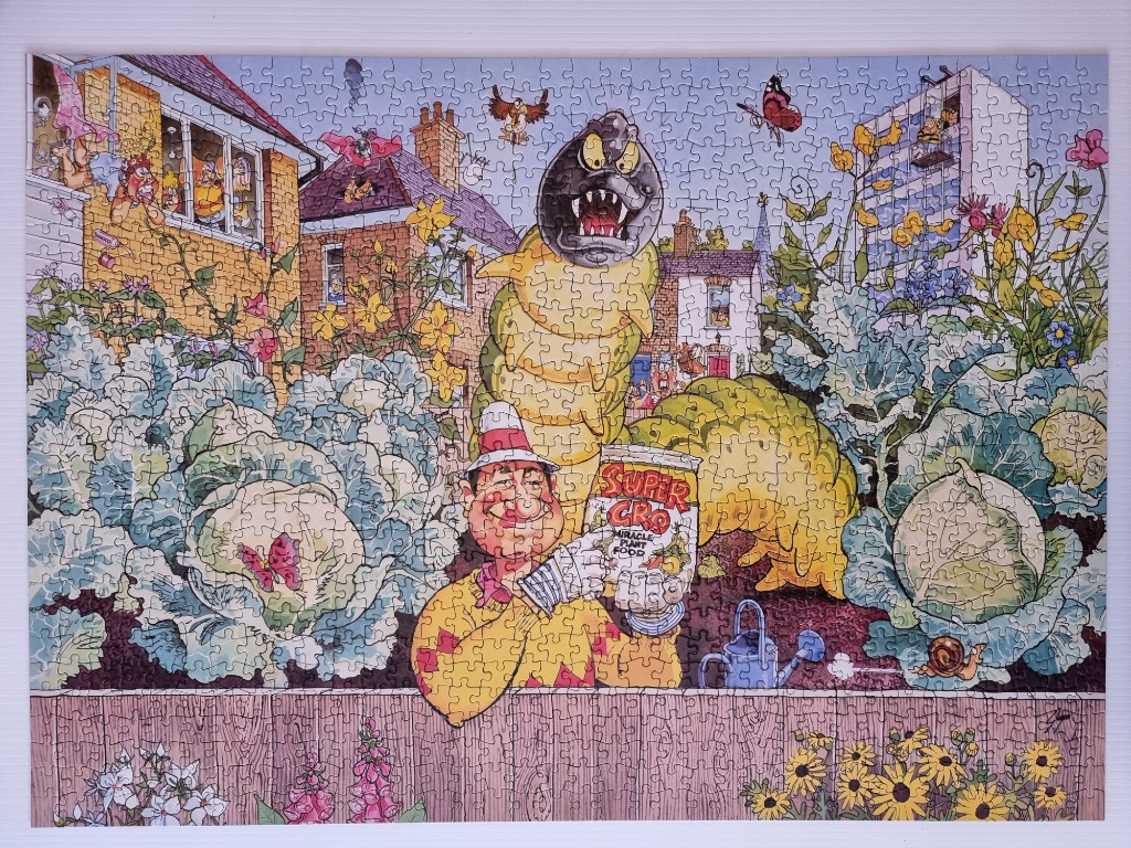 Whimsical garden scene with a giant caterpillar, cartoon man, and oversized vegetables.