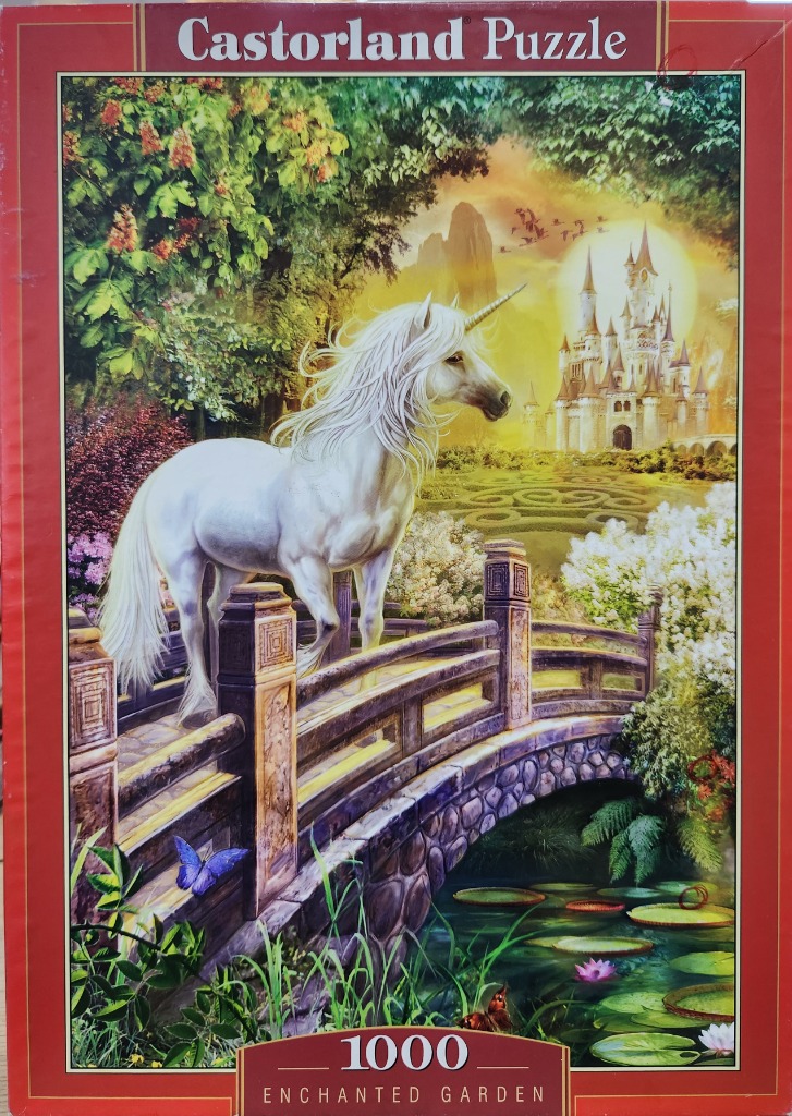 A white unicorn stands on a stone bridge in a fantasy garden with a castle in the distance at sunset.