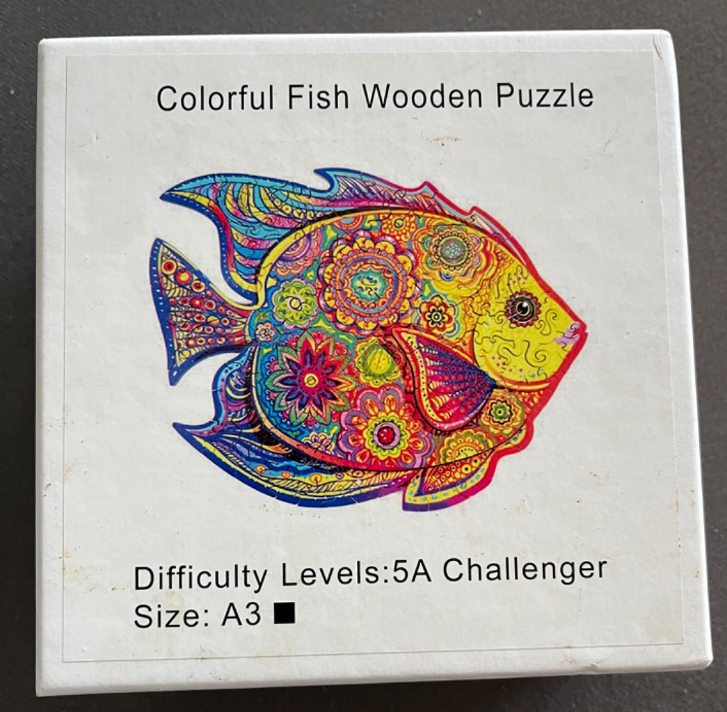 A vibrantly patterned, kaleidoscope-style illustration of a tropical fish featuring intricate floral and mandala designs.