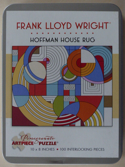 An abstract geometric artwork based on a Frank Lloyd Wright rug design, featuring circles, squares, and bold colors.