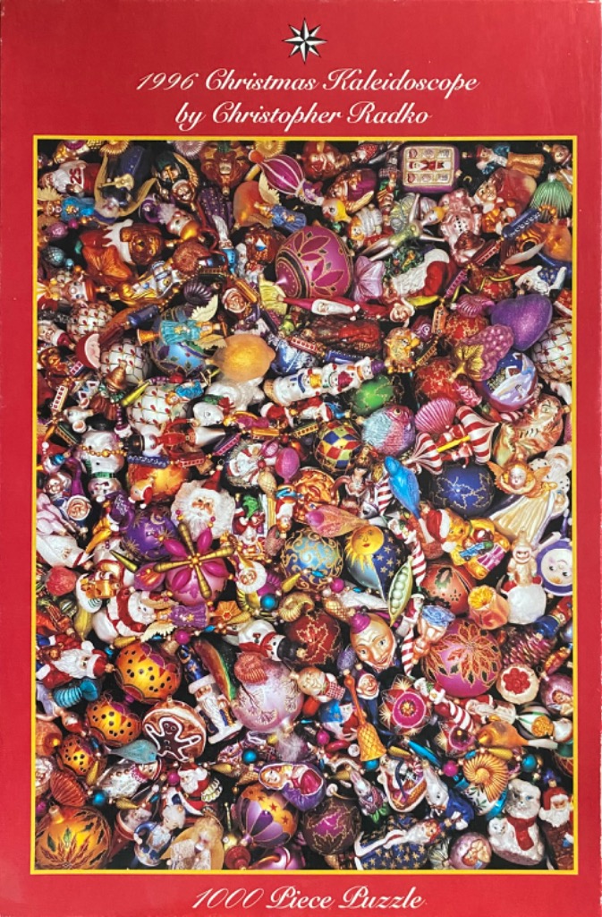 A dense, vibrant collection of ornate, colorful glass Christmas ornaments of various shapes and themes.