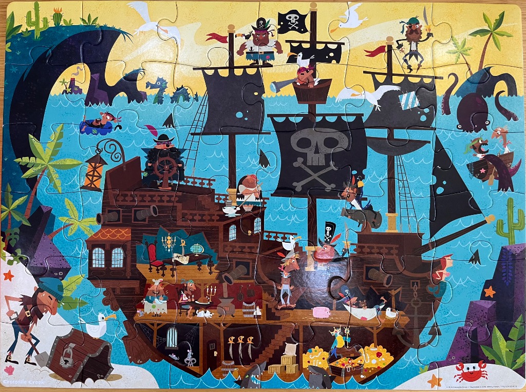 Cartoon illustration of a pirate ship sailing on a blue sea with various characters and sea creatures.