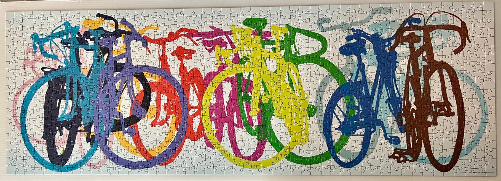 A panoramic illustration of multiple colorful bicycles layered over each other in a line.