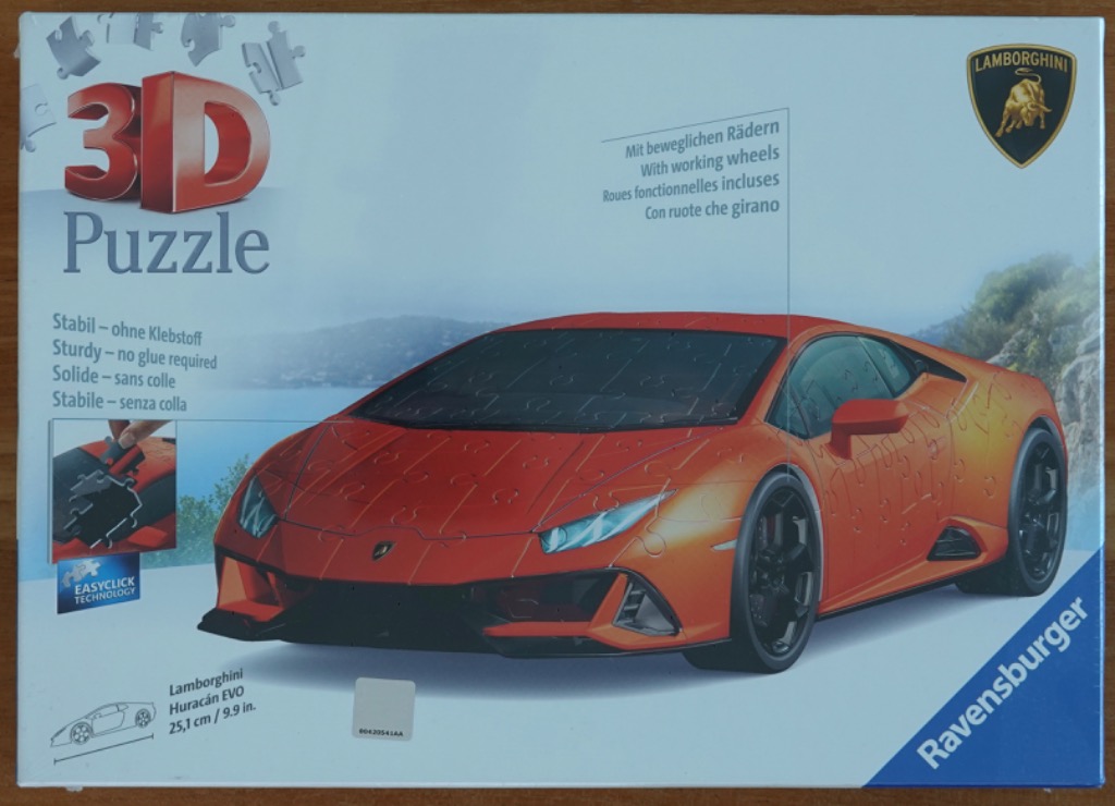 An orange Lamborghini Huracán EVO sports car shown against a coastal backdrop.