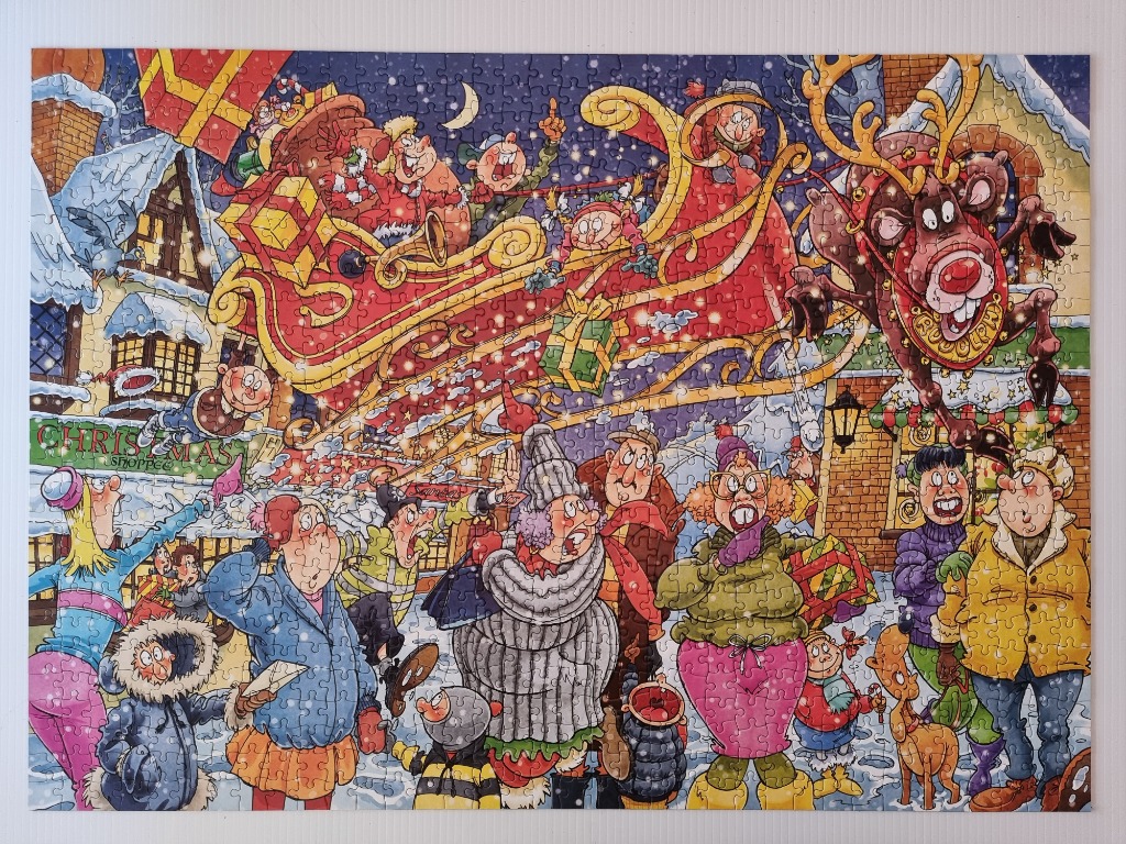 Christmas scene with Santa in a sleigh, reindeer, and a crowd of people in a snowy town.