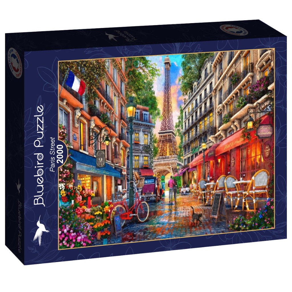 A romantic Parisian street scene featuring a red bicycle, cafe tables, and a view of the Eiffel Tower at sunset.