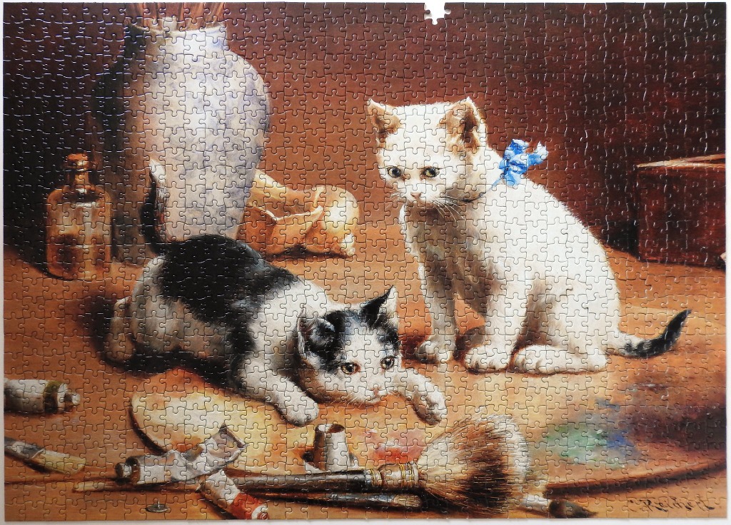 An oil painting of a black and white kitten playing near a white kitten in an artist's studio.