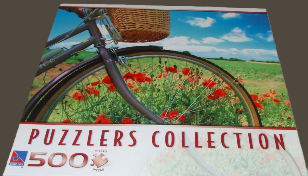 A purple bicycle with a wicker basket in a field of red poppies under a bright blue sky.