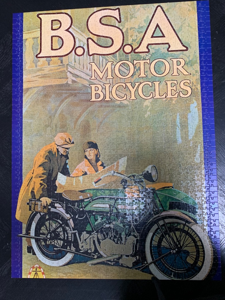 Vintage-style advertisement poster for B.S.A. Motor Bicycles featuring a man and woman with a motorcycle sidecar.