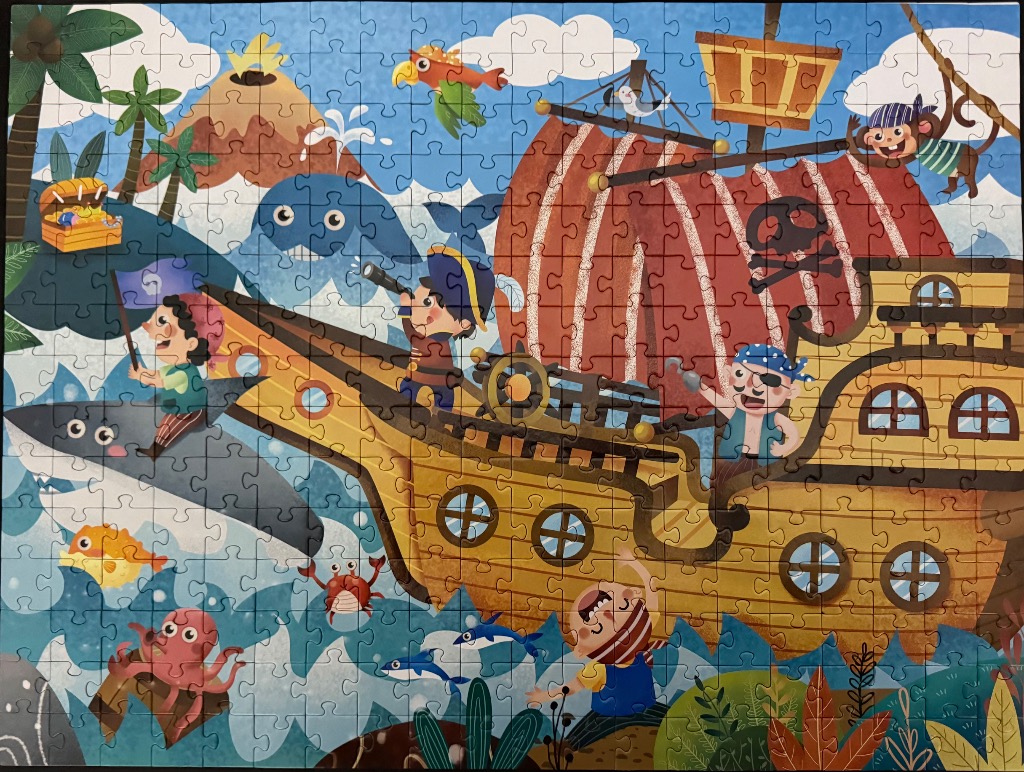 A colourful cartoon illustration of a pirate ship sailing on a tropical sea with pirate children and marine life.