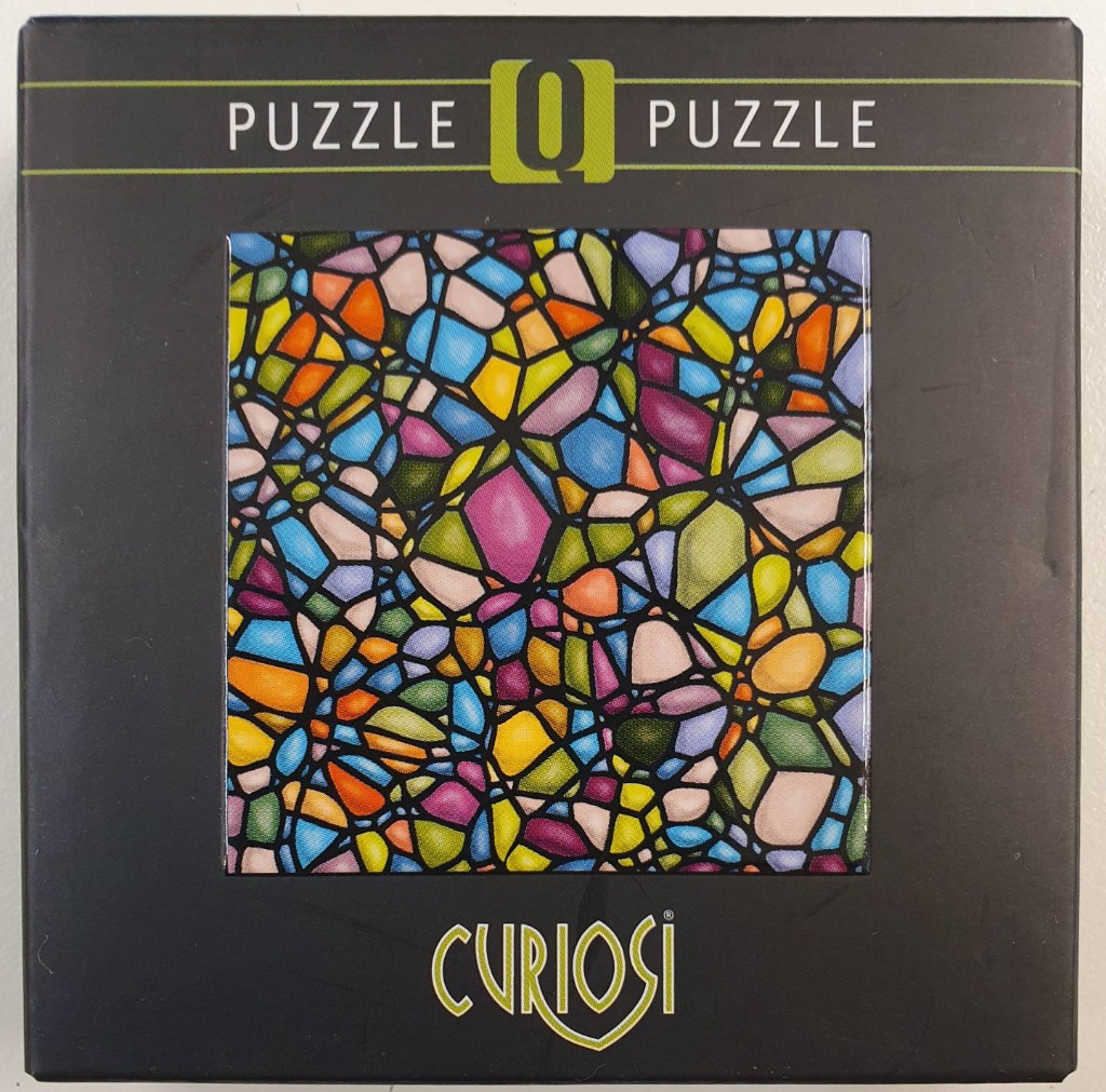 An abstract, mosaic-style pattern featuring multicolored, irregular stained glass shapes separated by thick black lines.