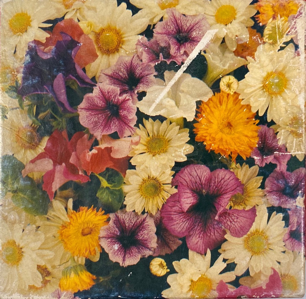 A close-up, top-down view of a dense, vibrant bouquet of daisies, petunias, and marigolds.