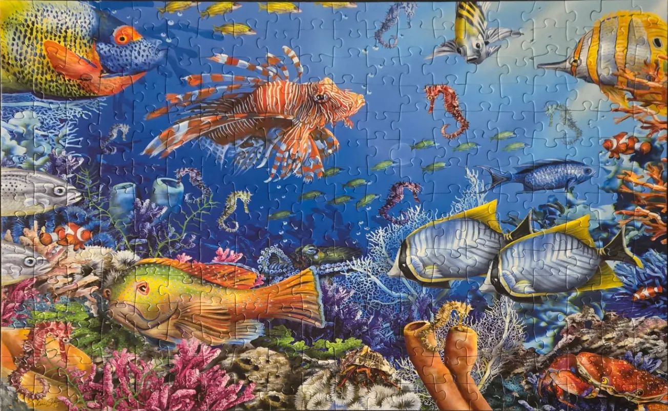 Vibrant coral reef scene filled with tropical fish, seahorses, and marine life.