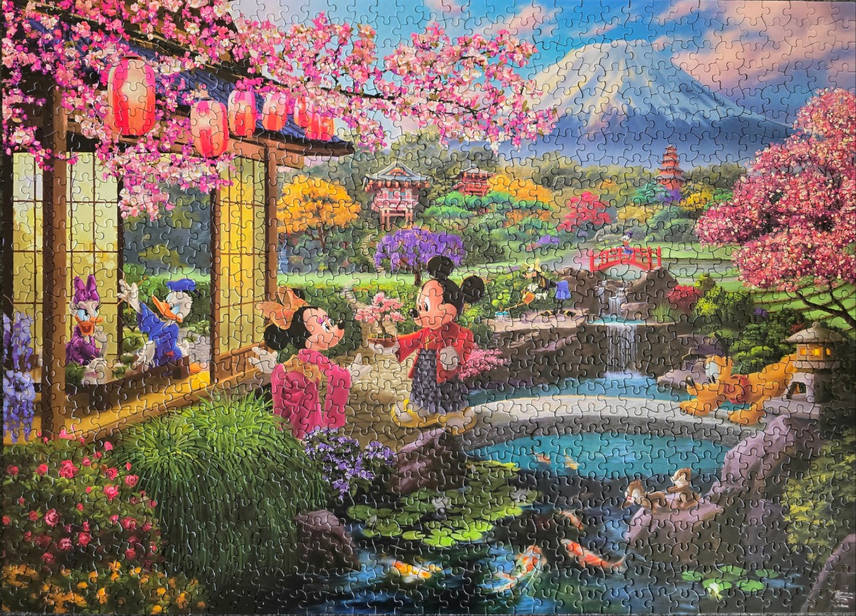 Mickey and Minnie Mouse in a Japanese-style garden with cherry blossoms and Mount Fuji in the background.