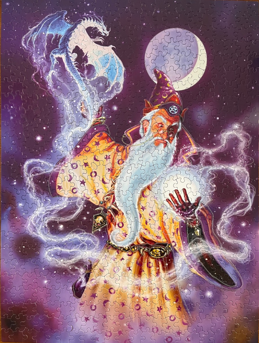 An elderly wizard in a golden robe casting a spell with a white dragon against a purple night sky with a crescent moon.