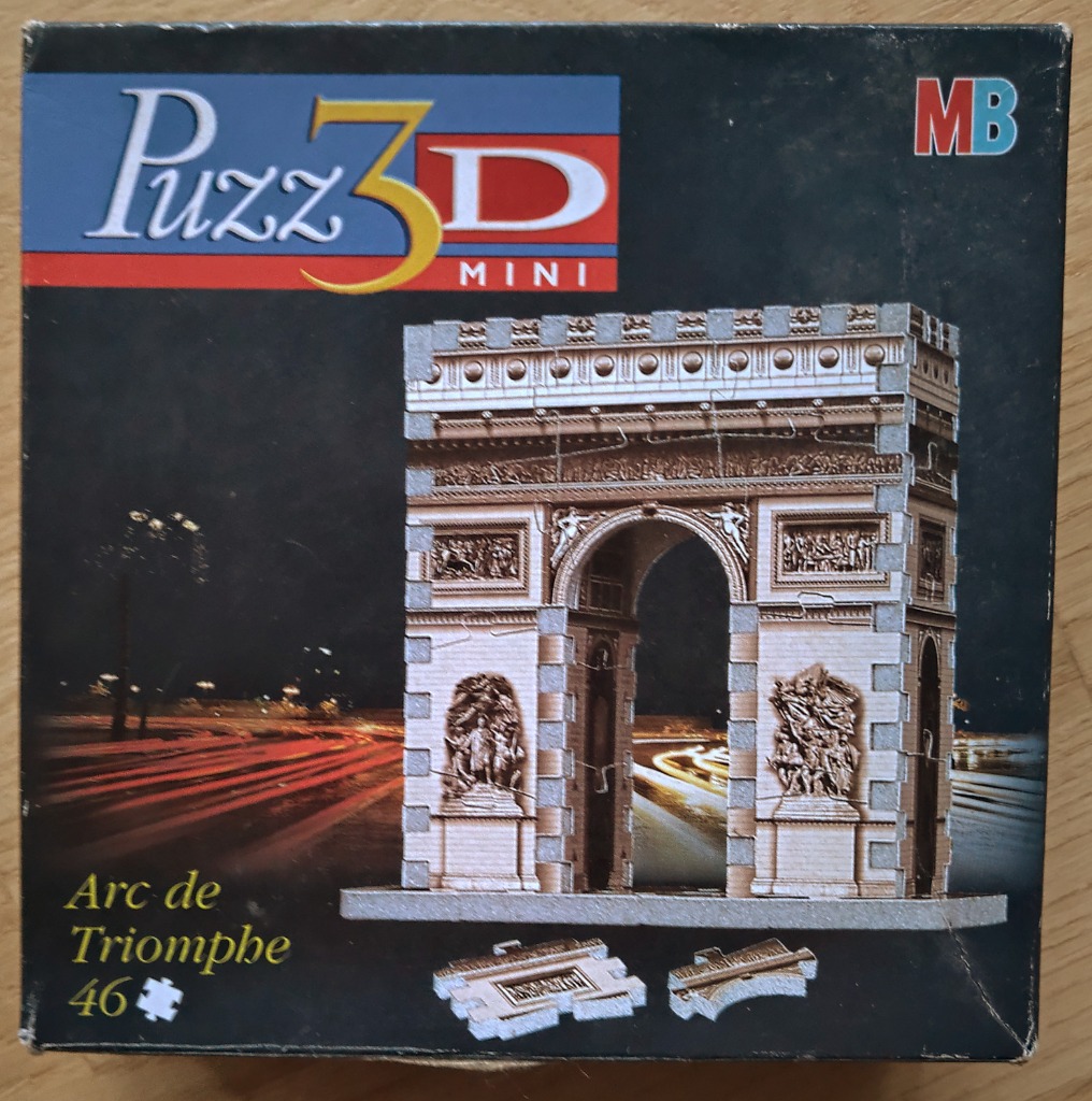 A 3D model of the Arc de Triomphe set against a blurred Parisian night street scene with light trails.