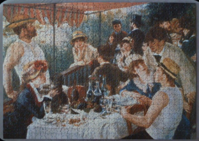 A reproduction of the painting Luncheon of the Boating Party showing friends dining on a terrace.