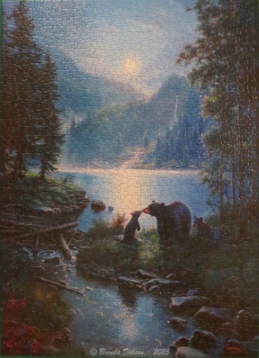 A mother bear and two cubs stand by a serene mountain lake at sunrise in an oil painting style.