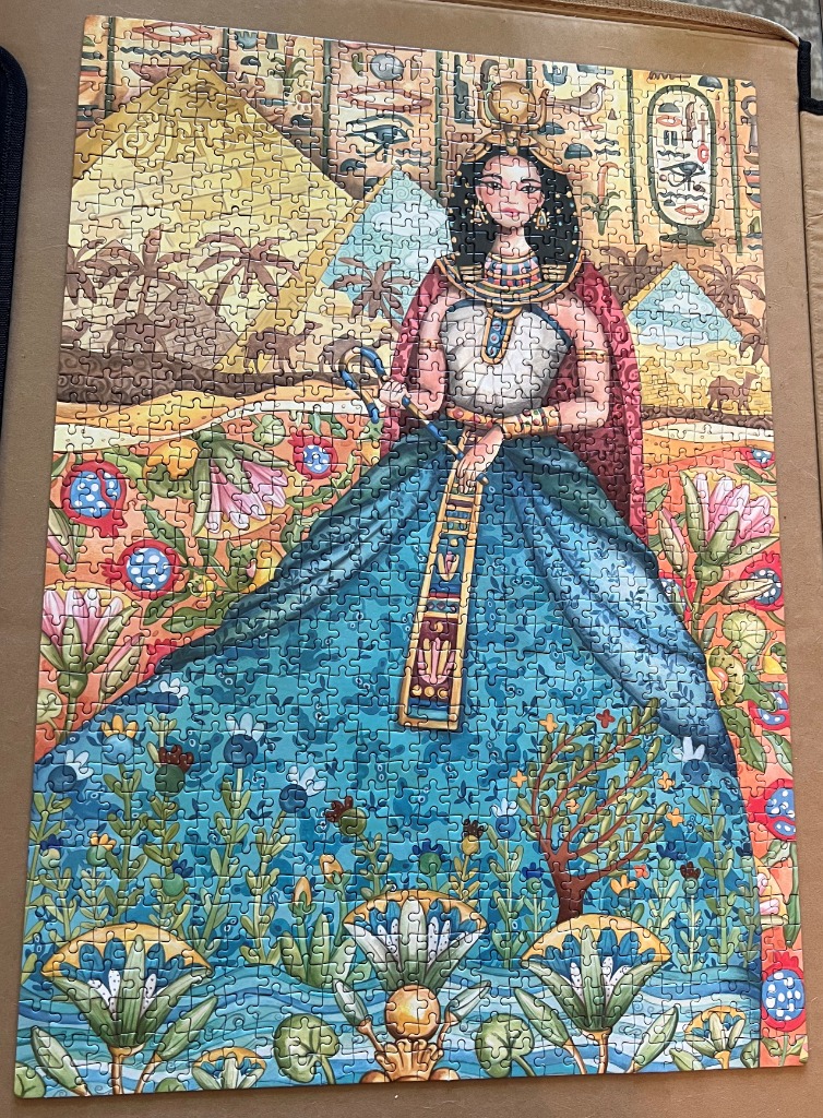 Illustration of an Egyptian queen standing in a field of lotus flowers with pyramids in the background.