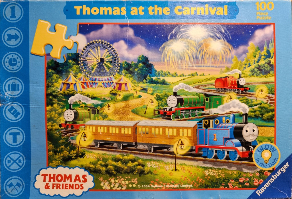 Illustration of Thomas the Tank Engine and friends at a carnival with fireworks in the night sky.