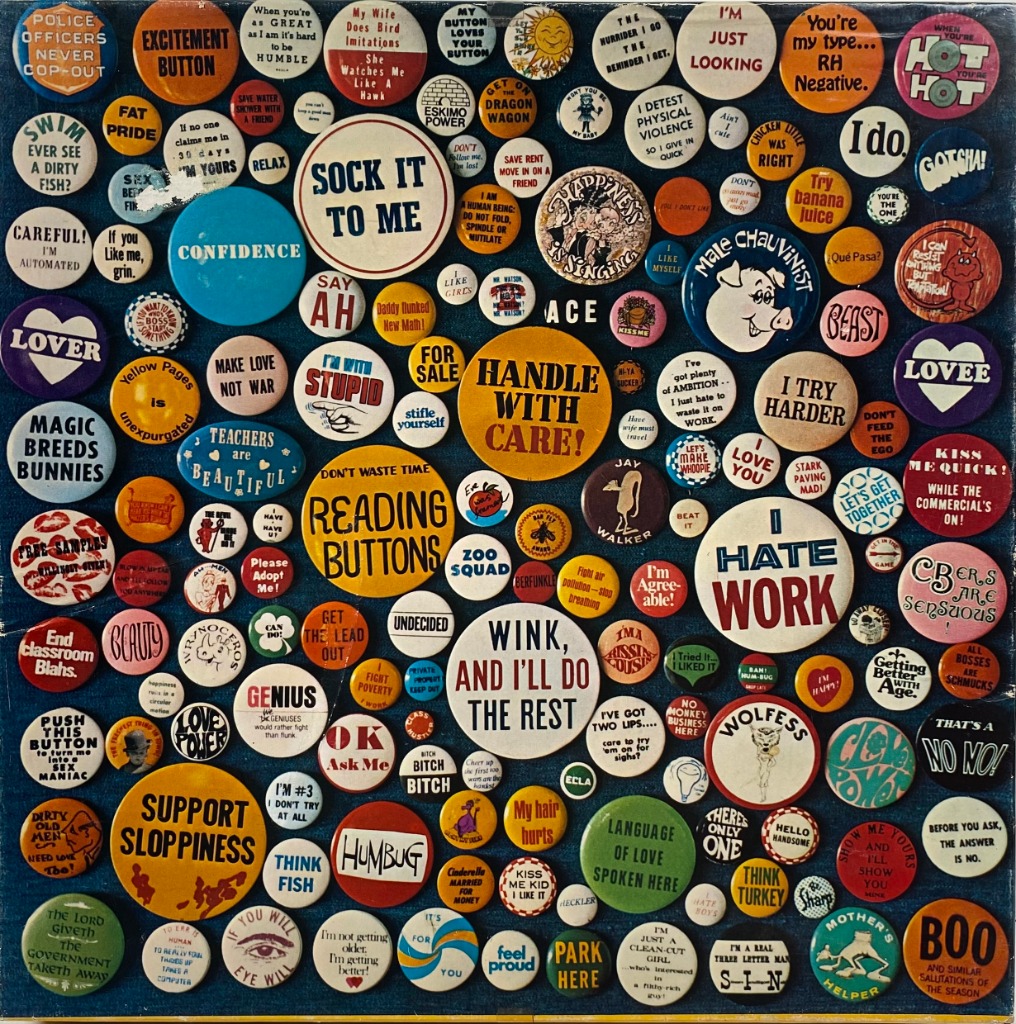 A dense collage of vintage round pinback buttons featuring various slogans and illustrations on a dark blue background.