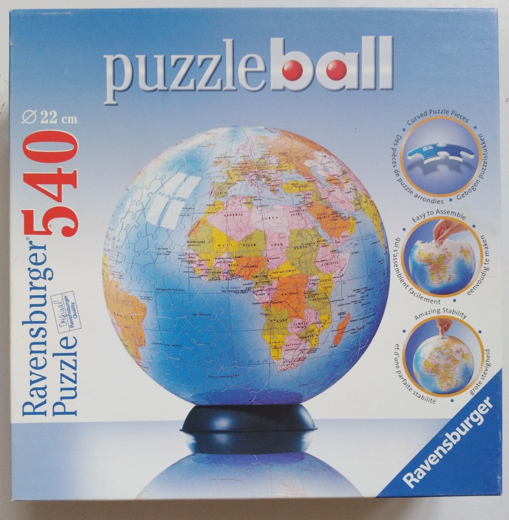A spherical world globe map puzzle on a stand against a blue background.