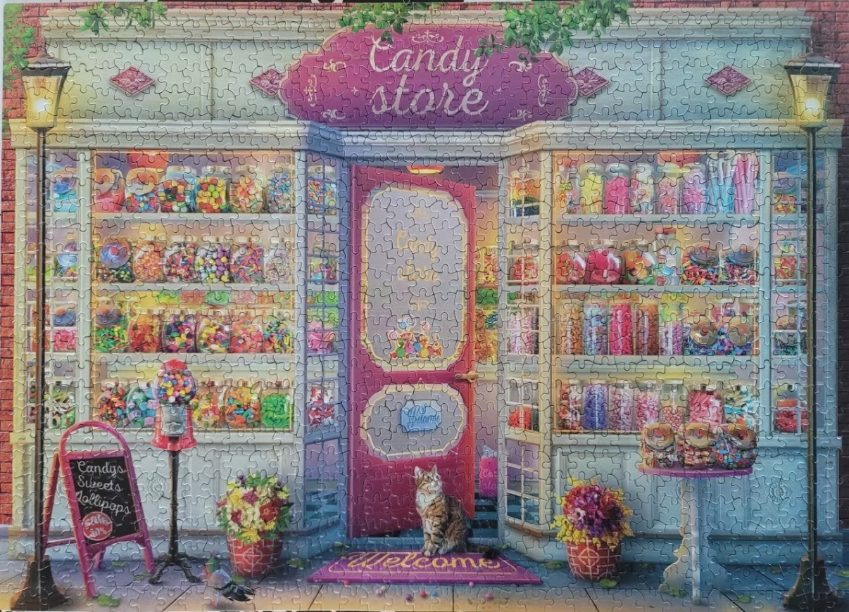 A charming street-level view of a vibrant candy store with a cat sitting outside the door.