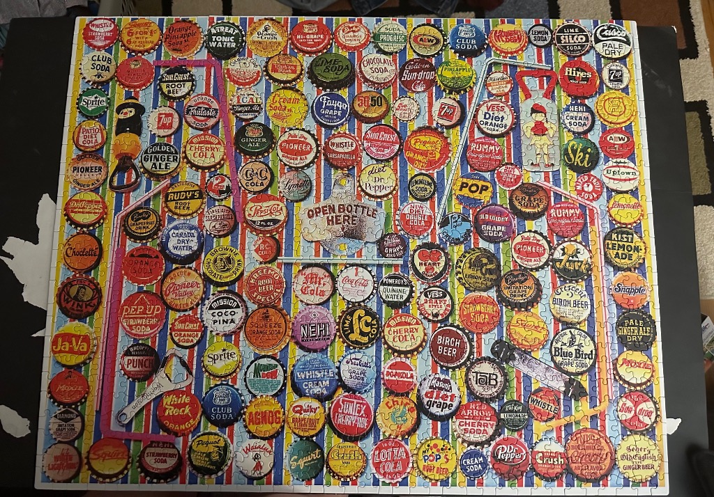 A collection of vintage soda bottle caps arranged on a colorful striped background.