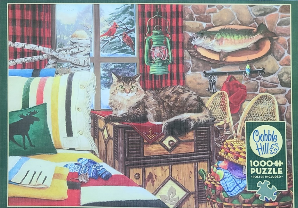A fluffy brown tabby cat resting on a rustic wooden cabinet in a cozy, snow-dusted lodge setting.