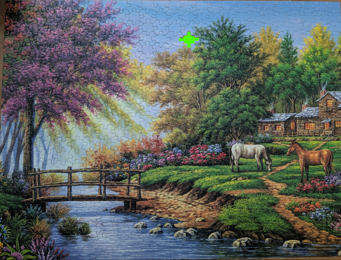 A peaceful rural landscape with a small wooden bridge over a stream, a log cabin, and two horses grazing.