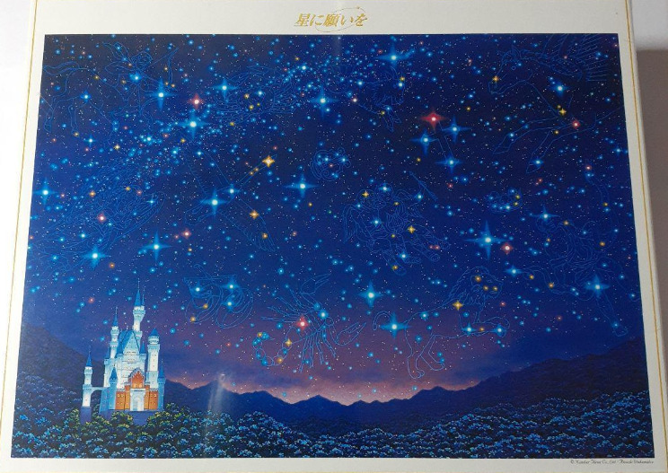 A fairytale castle stands under a vast night sky filled with glowing constellations and zodiac symbols.