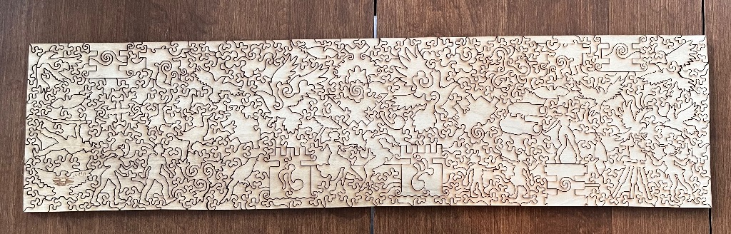 Laser-cut wooden art featuring a complex, swirling fantasy landscape of birds, figures, and castle turrets.