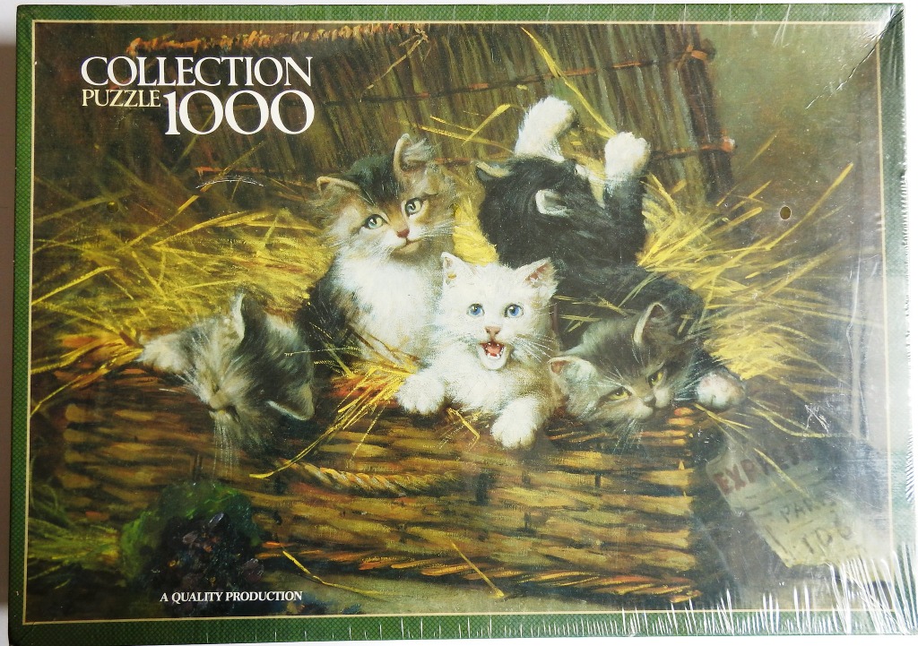 Four kittens playing inside a wicker basket filled with straw.