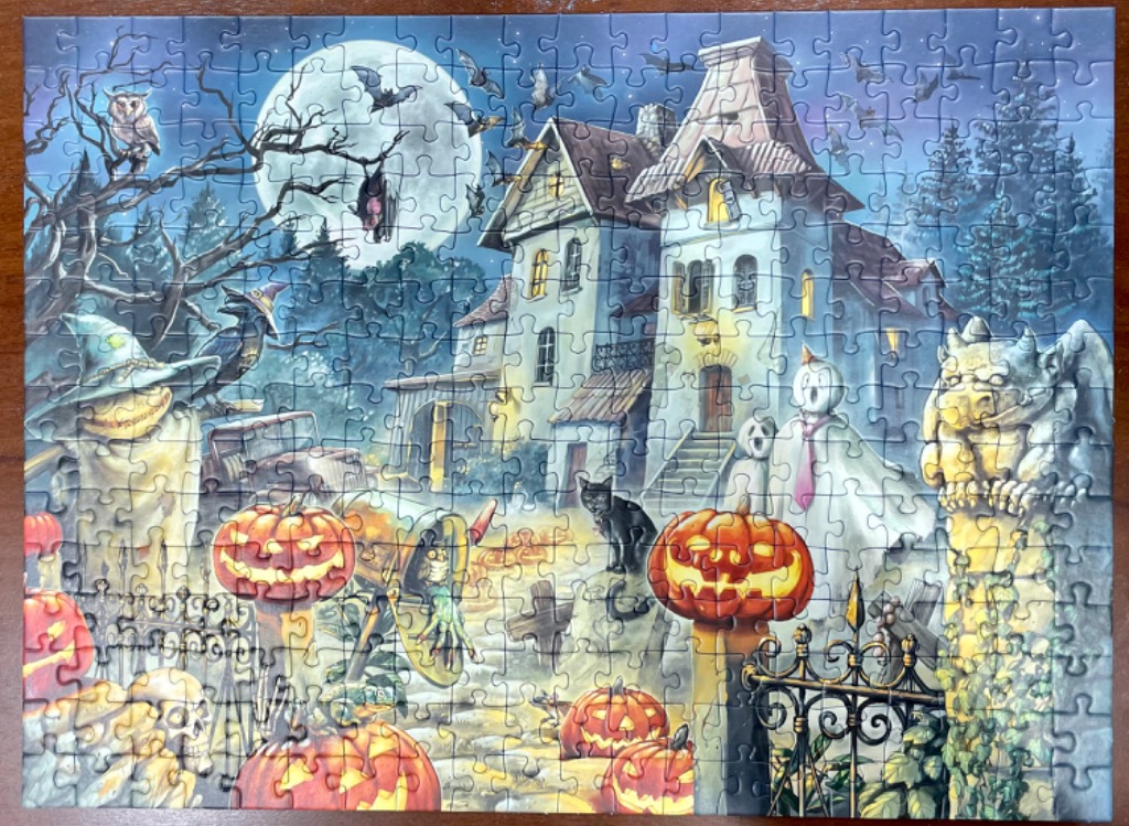 A whimsical Halloween scene featuring a haunted mansion, jack-o