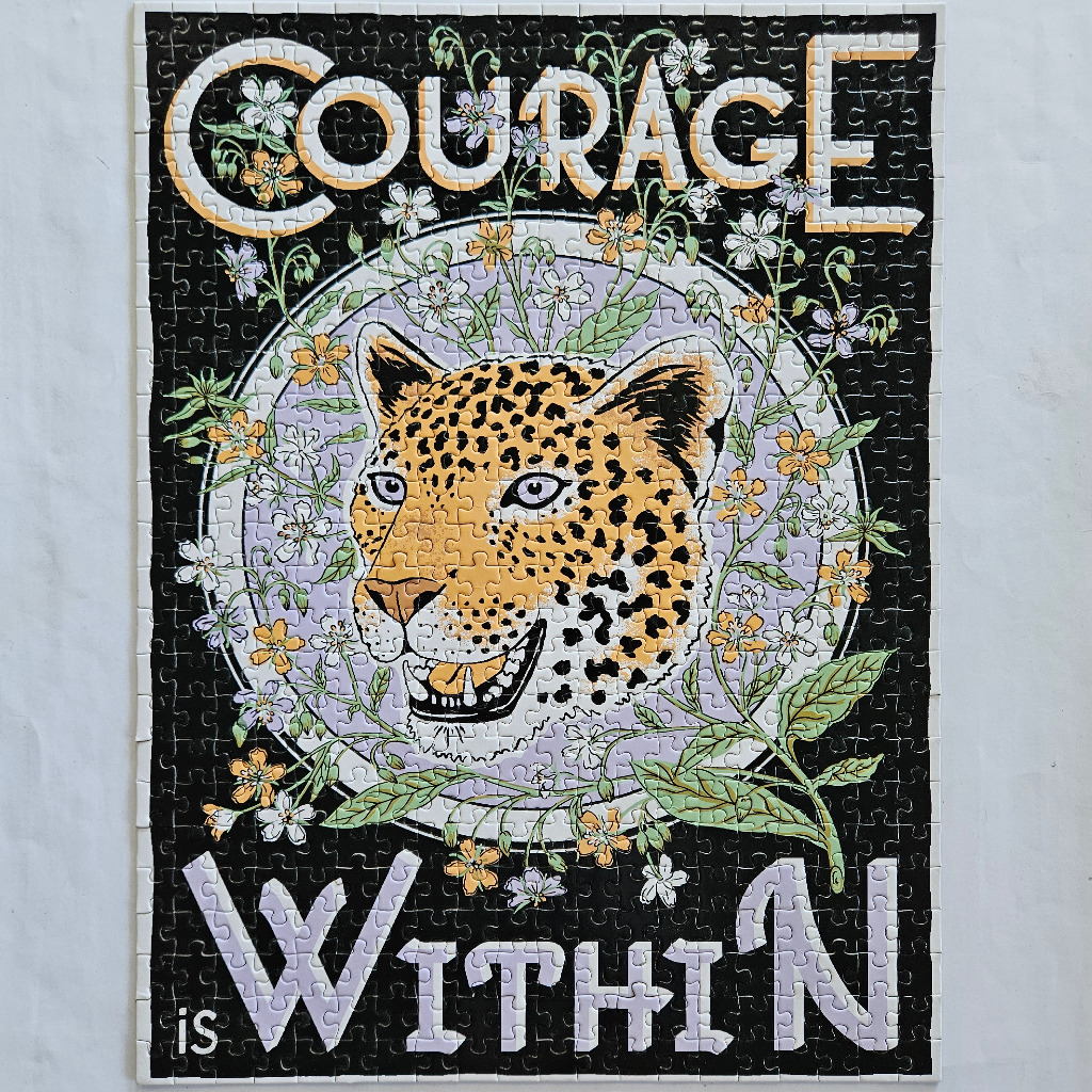 Artistic illustration of a leopard surrounded by flowers with the text COURAGE IS WITHIN