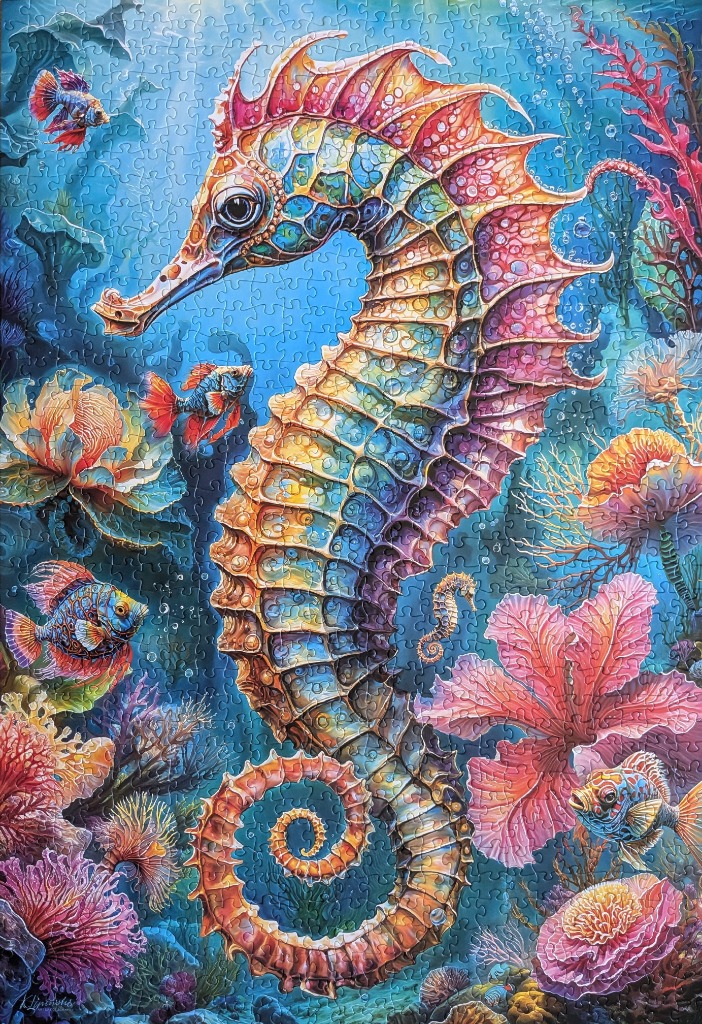 A vibrant, multi-coloured seahorse swimming in a coral reef with tropical fish and flowers.