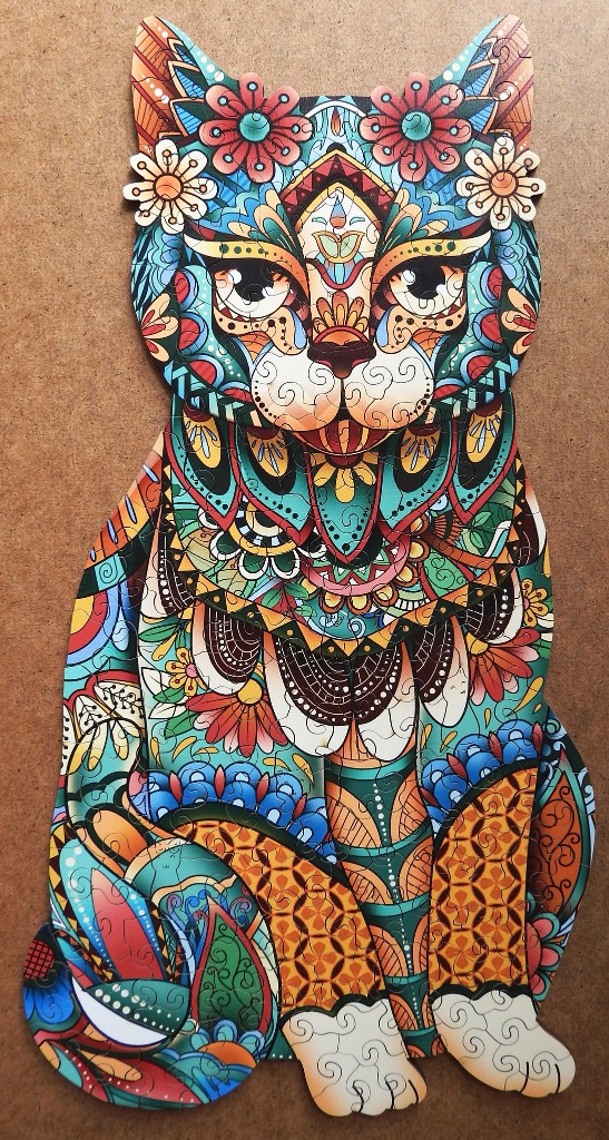 Stylized illustration of a cat decorated with intricate floral and paisley patterns in a vibrant, kaleidoscopic palette.